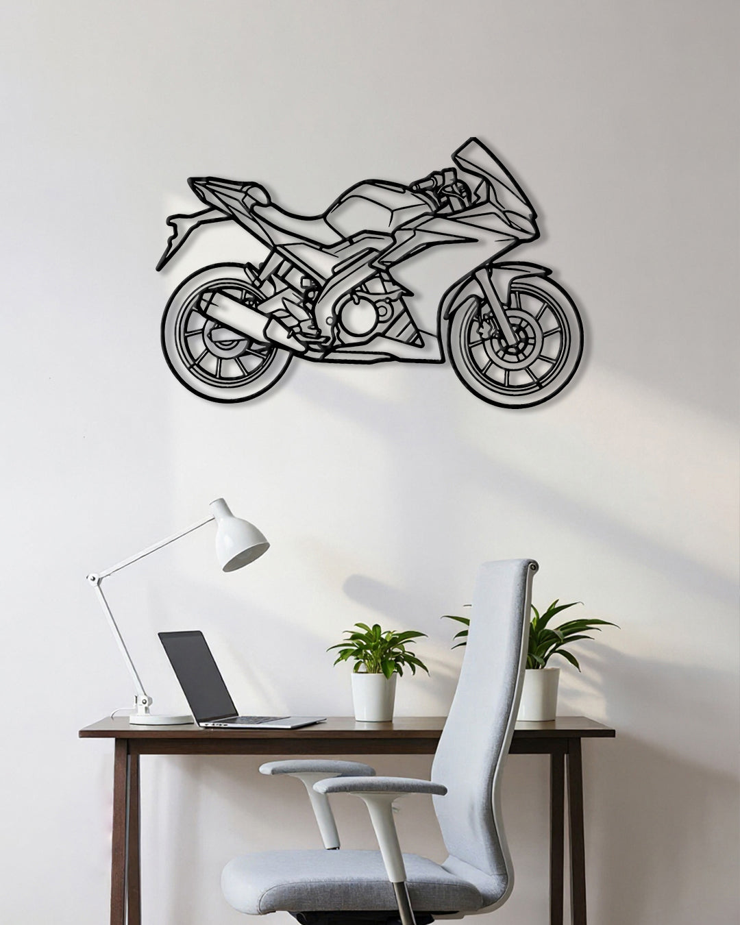 Motorcycle cutout shape made of black metal hanging on the wall