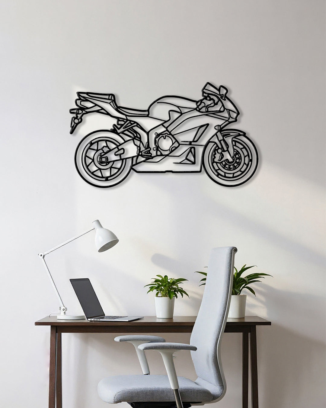 Motorcycle cutout shape made of black metal hanging on the wall
