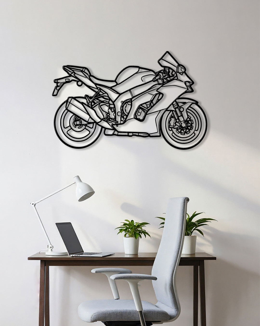 Motorcycle cutout shape made of black metal hanging on the wall