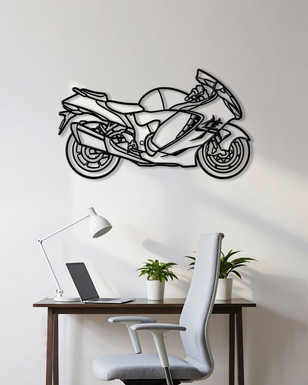 Motorcycle cutout shape made of black metal hanging on the wall