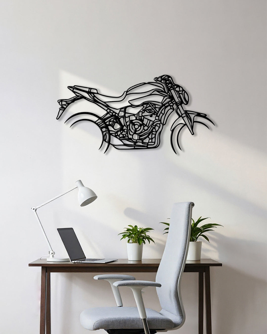 Motorcycle cutout shape made of black metal hanging on the wall