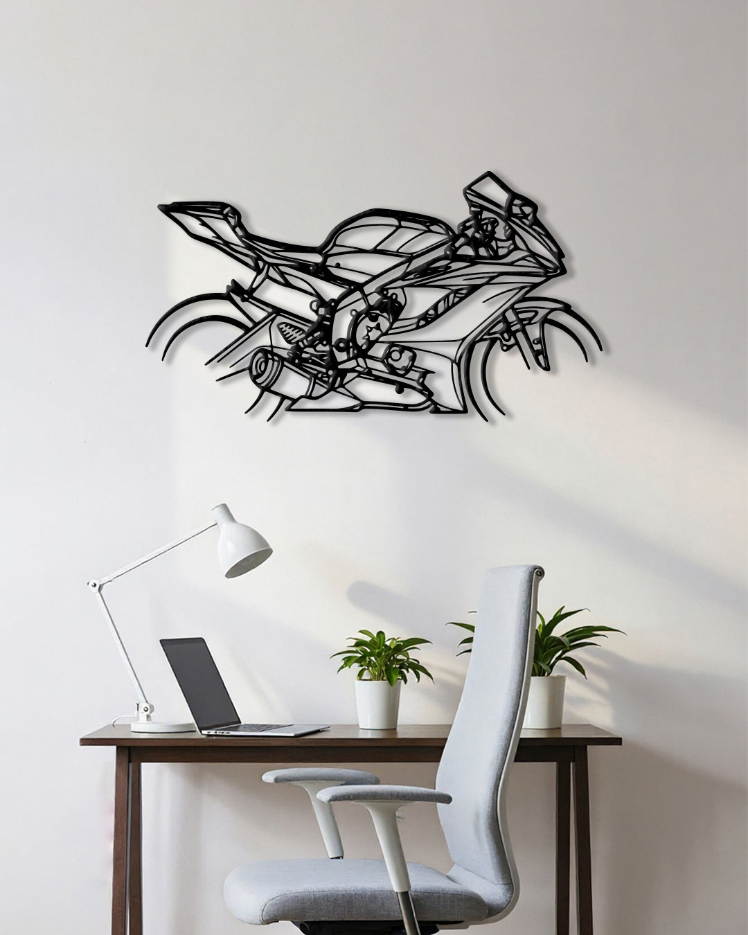 Motorcycle cutout shape made of black metal hanging on the wall