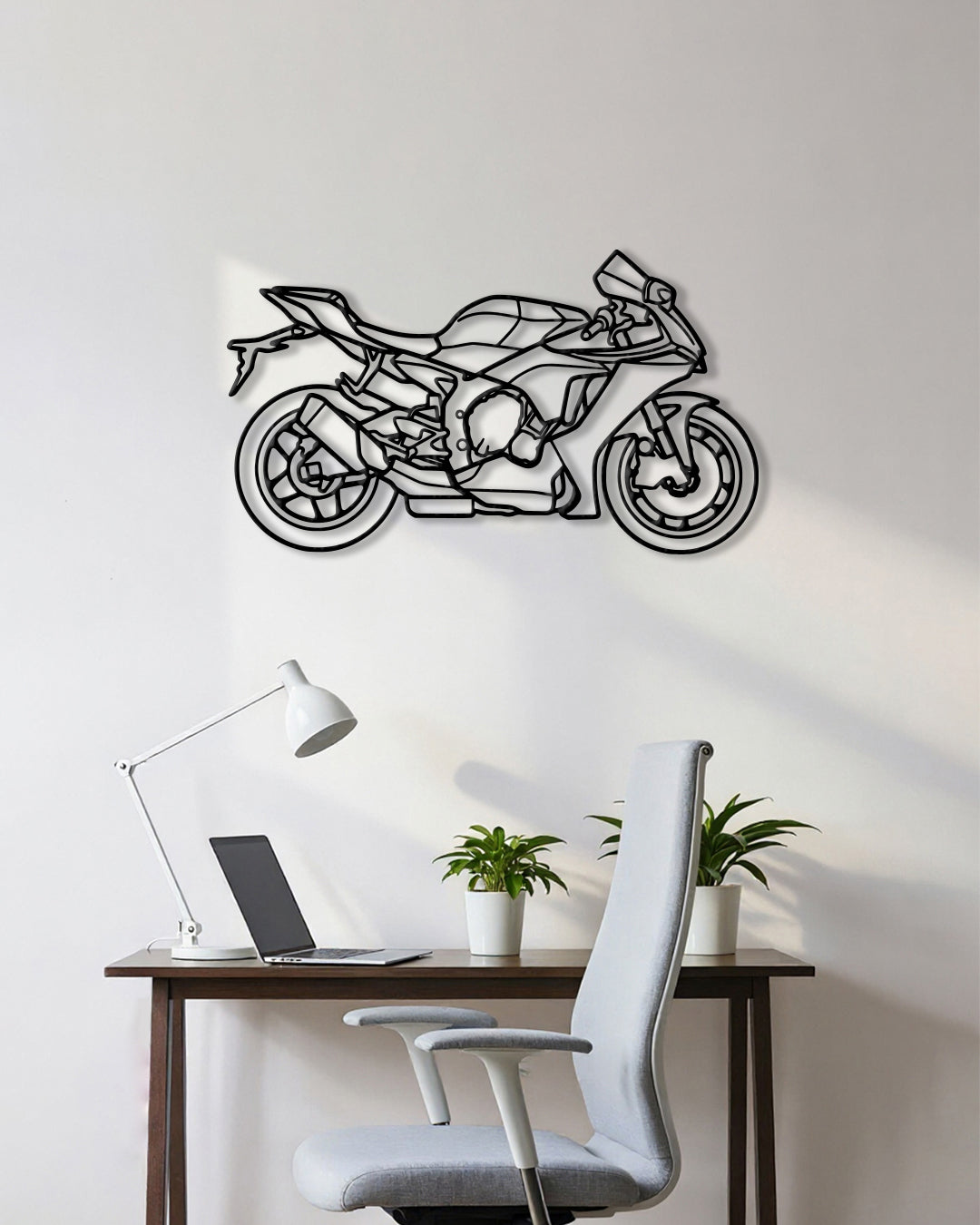 Motorcycle cutout shape made of black metal hanging on the wall