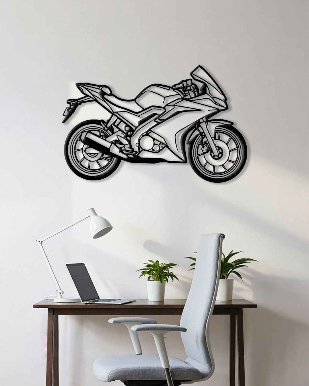 Motorcycle cutout shape made of black metal hanging on the wall
