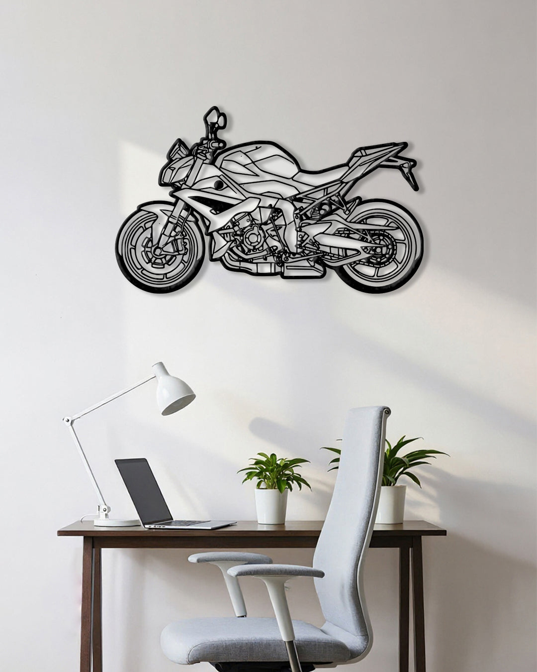 Motorcycle cutout shape made of black metal hanging on the wall
