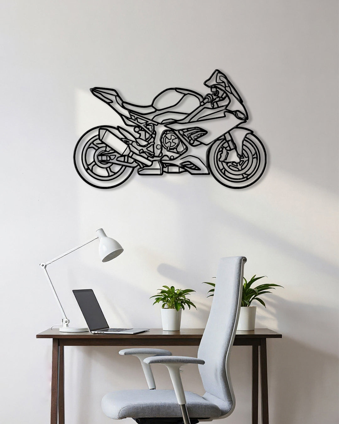 Motorcycle cutout shape made of black metal hanging on the wall