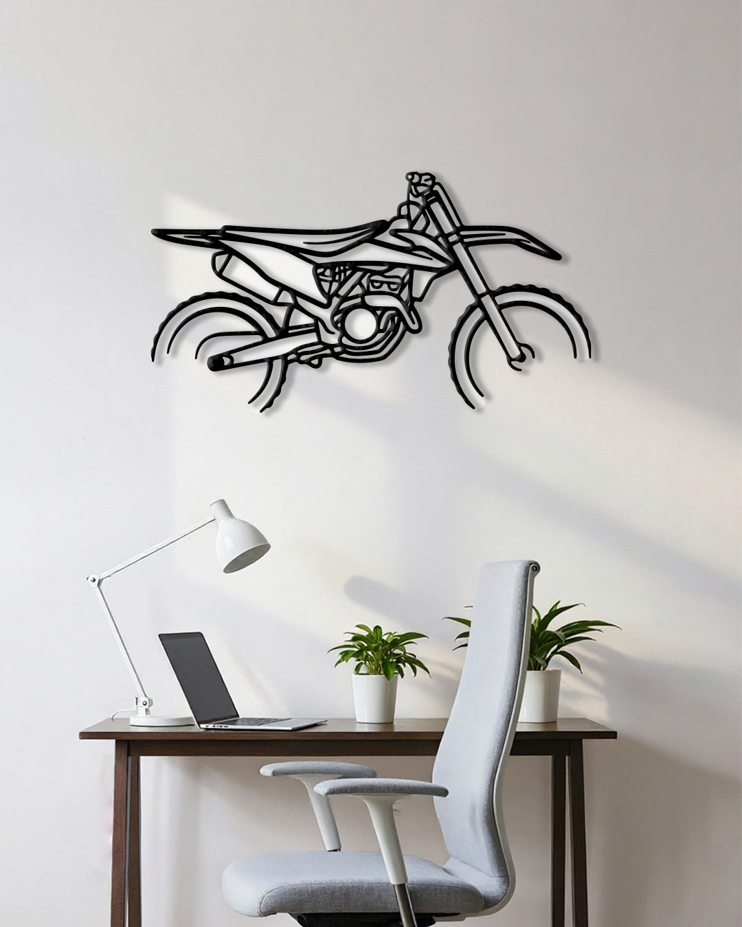 Motorcycle cutout shape made of black metal hanging on the wall