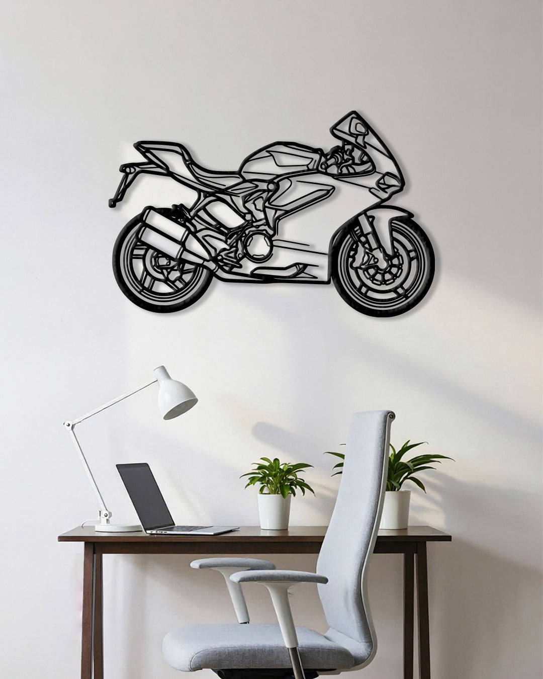Motorcycle cutout shape made of black metal hanging on the wall