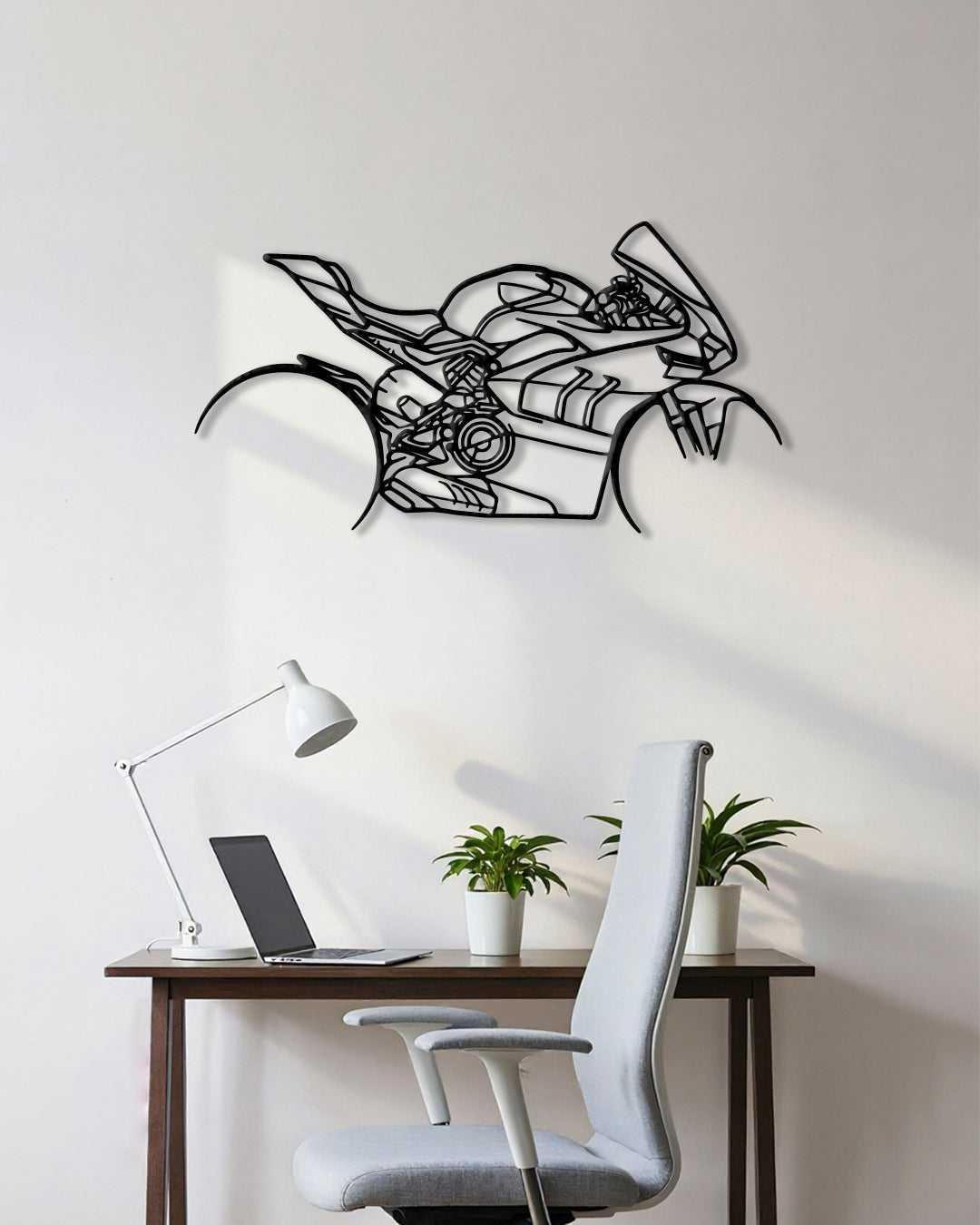 Motorcycle cutout shape made of black metal hanging on the wall