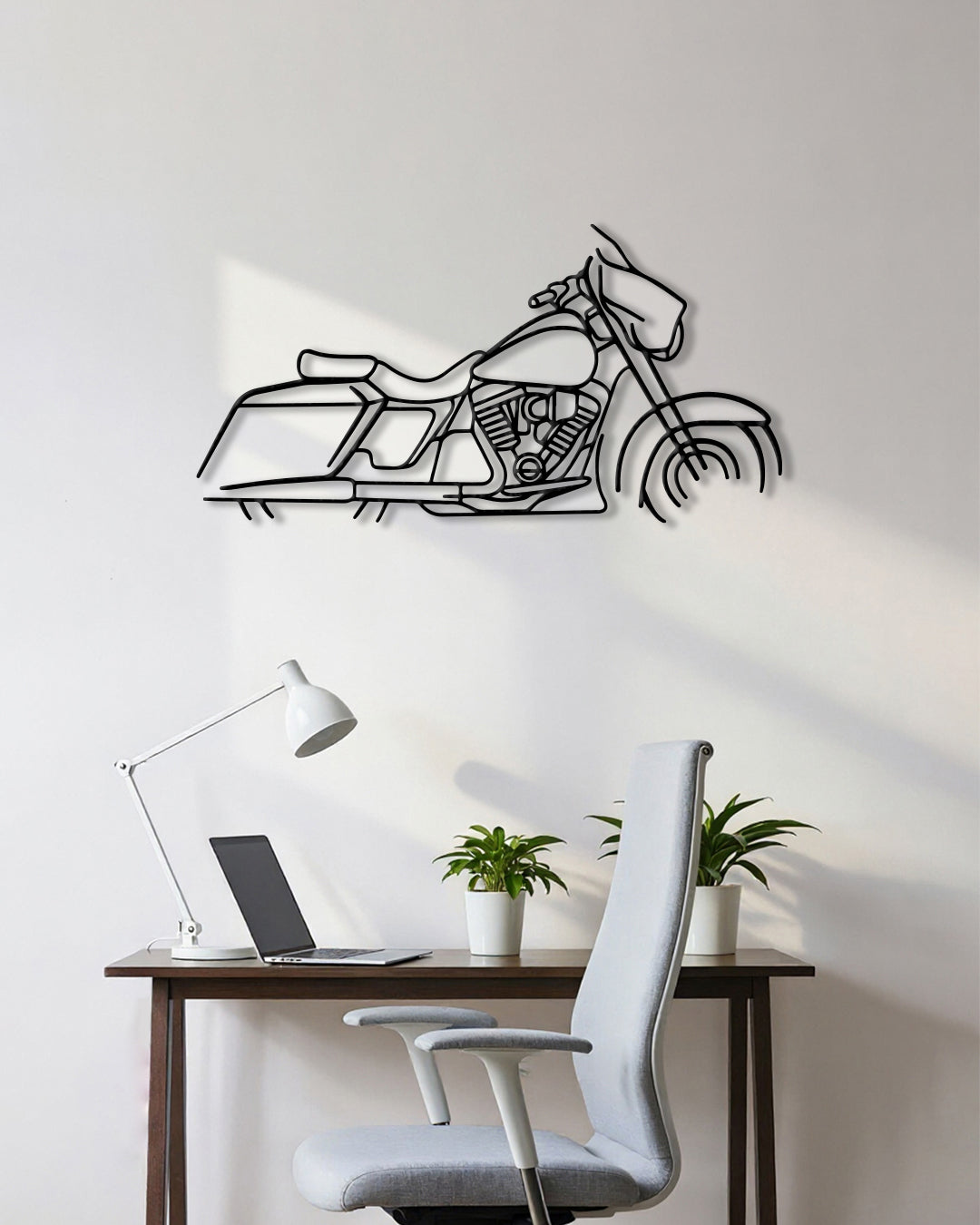 Motorcycle cutout shape made of black metal hanging on the wall