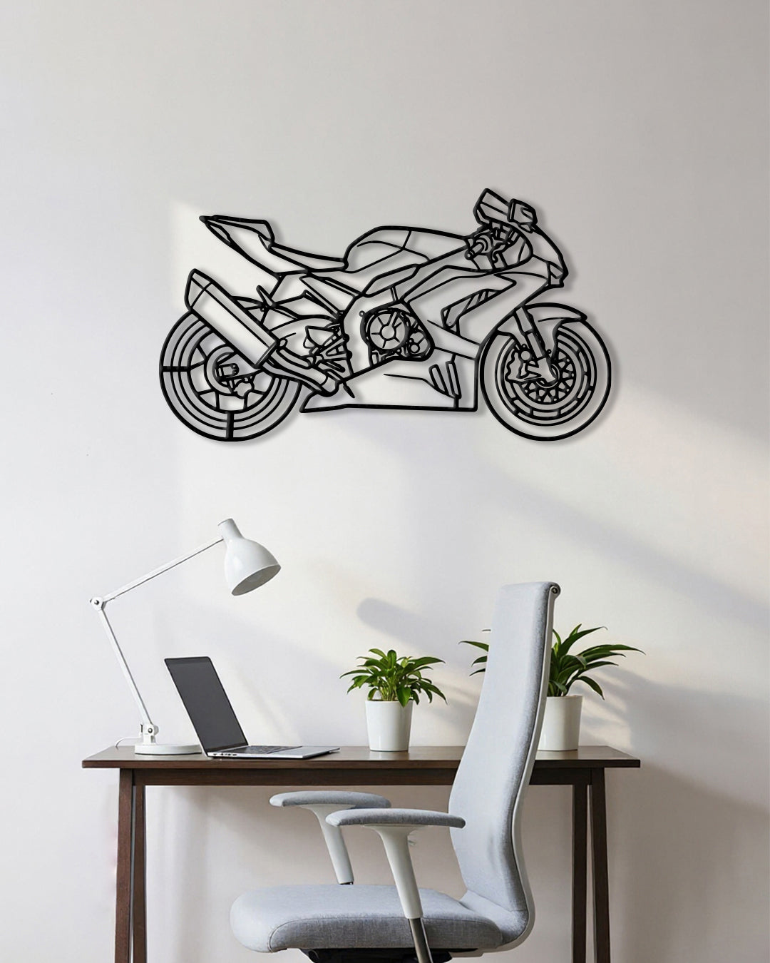 Motorcycle cutout shape made of black metal hanging on the wall