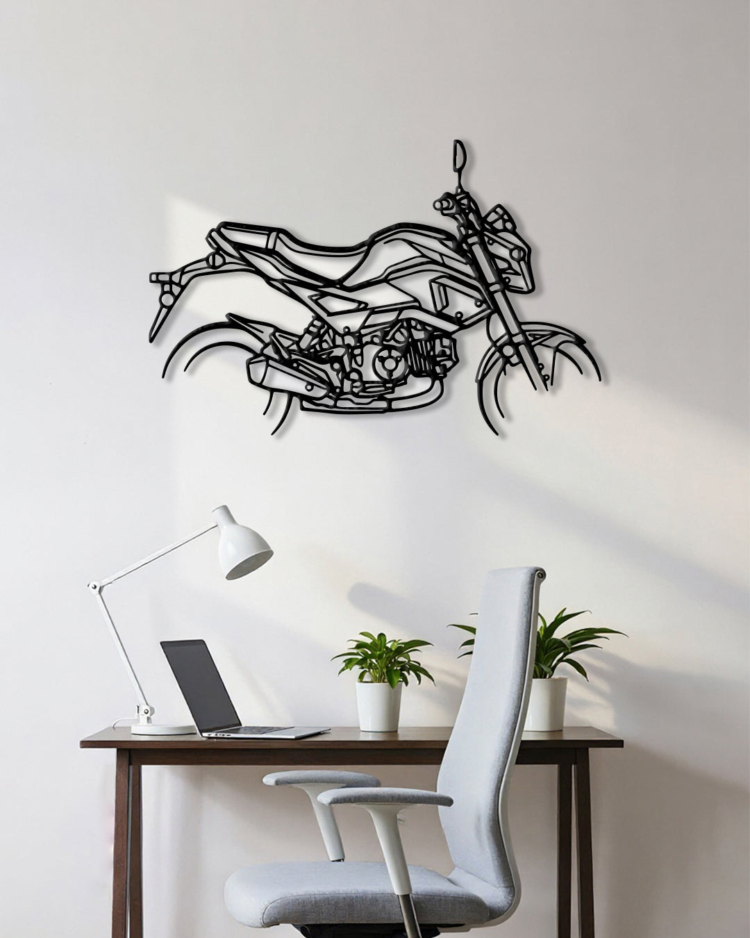 Motorcycle cutout shape made of black metal hanging on the wall