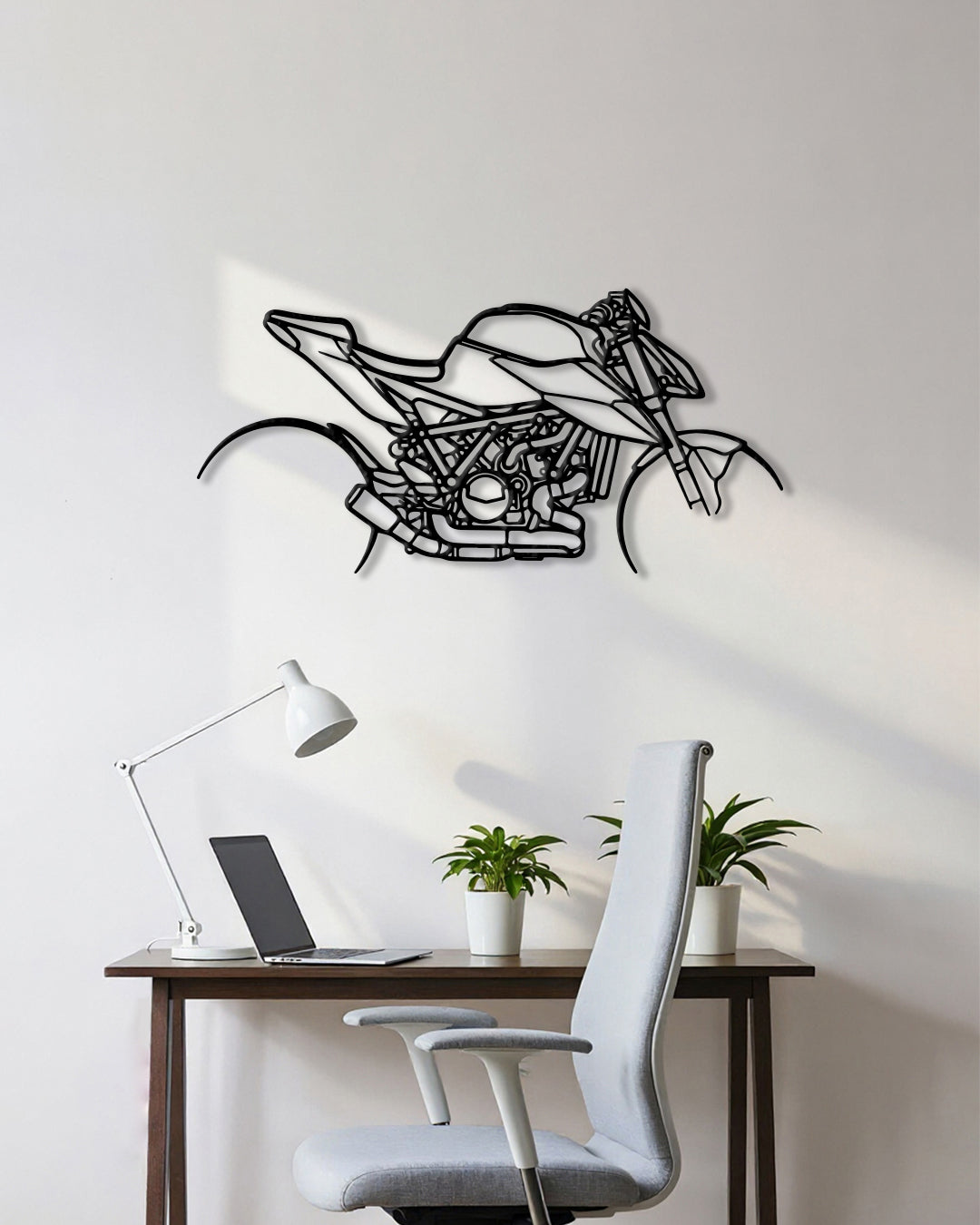 Motorcycle cutout shape made of black metal hanging on the wall