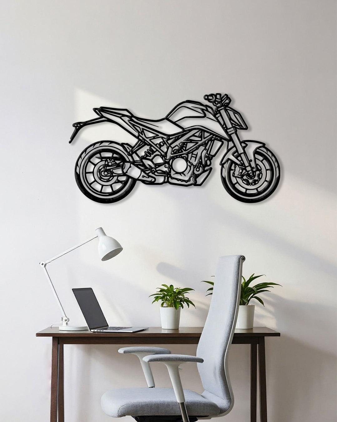 Motorcycle cutout shape made of black metal hanging on the wall