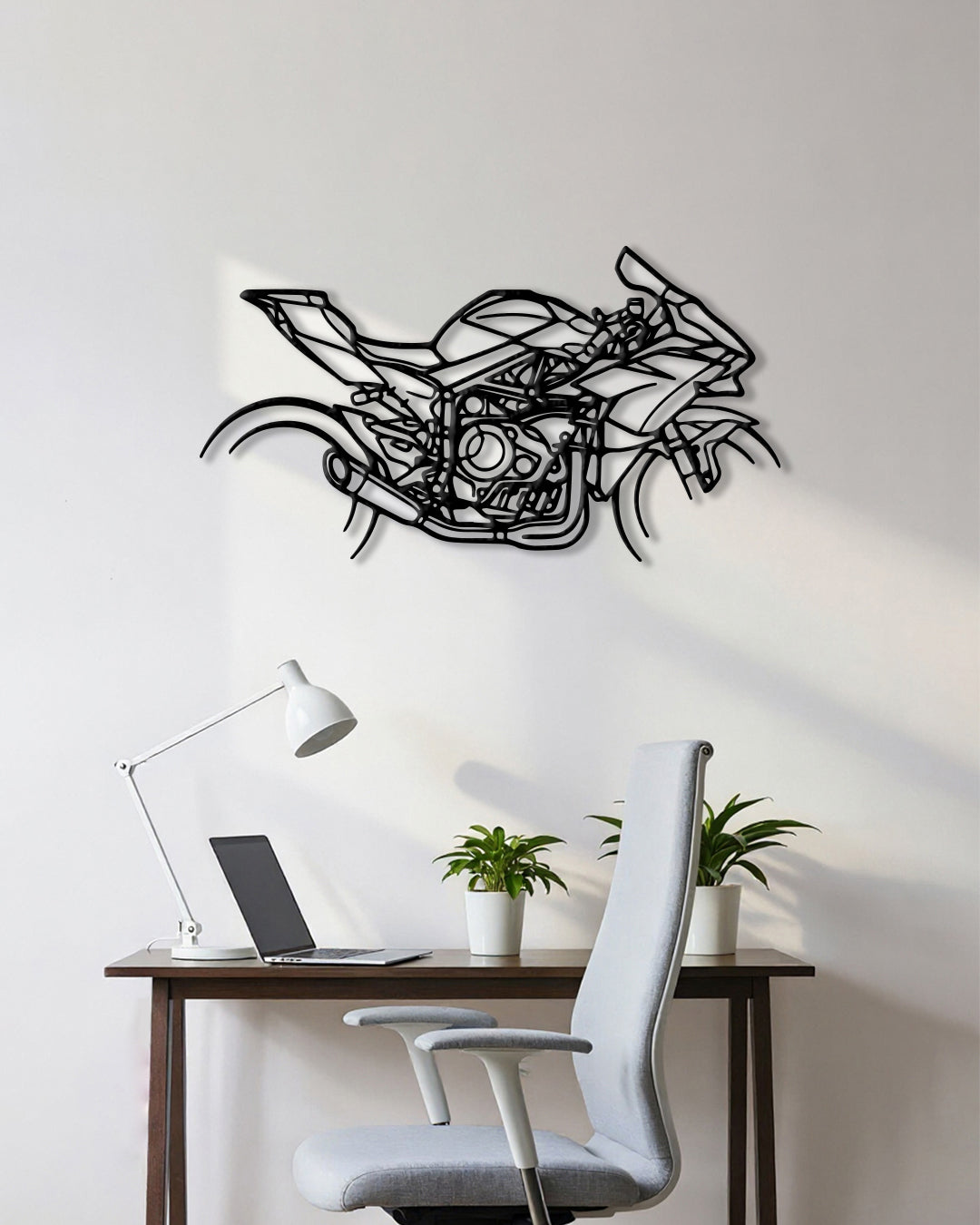 Motorcycle cutout shape made of black metal hanging on the wall