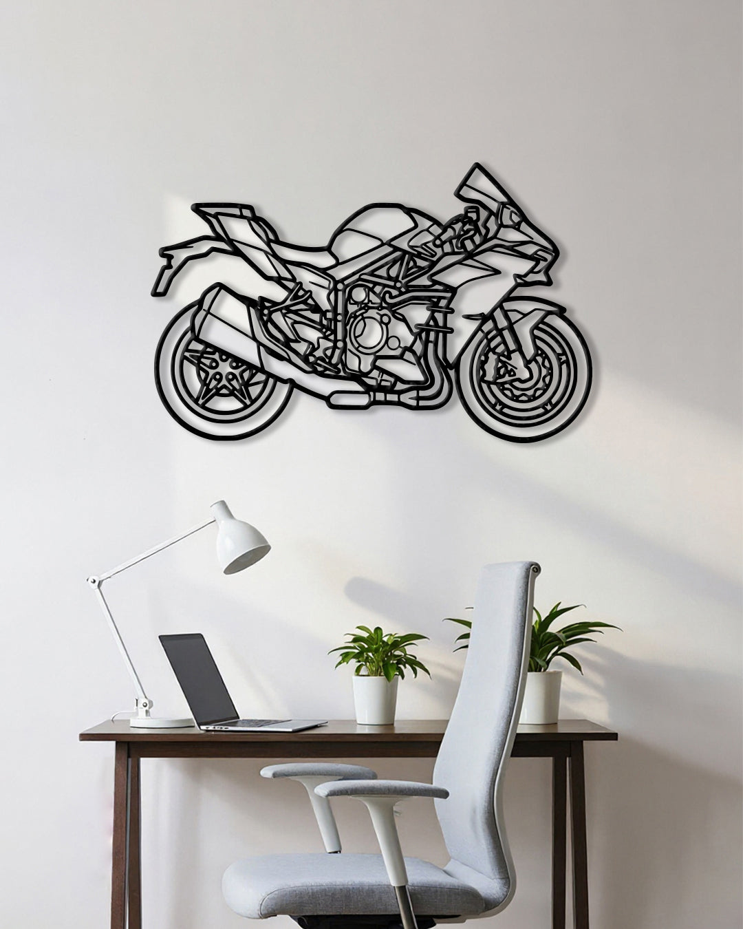 Motorcycle cutout shape made of black metal hanging on the wall