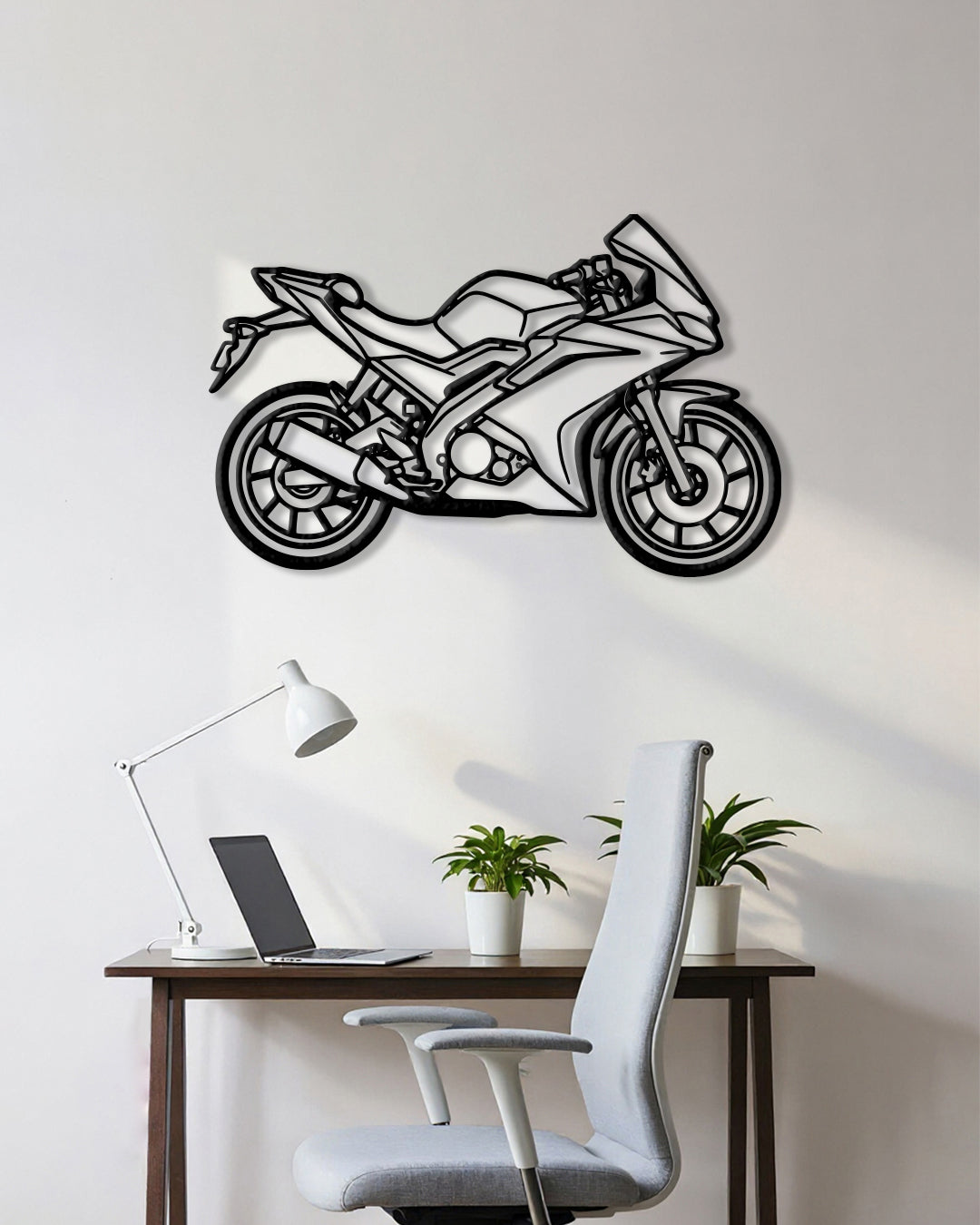 Motorcycle cutout shape made of black metal hanging on the wall