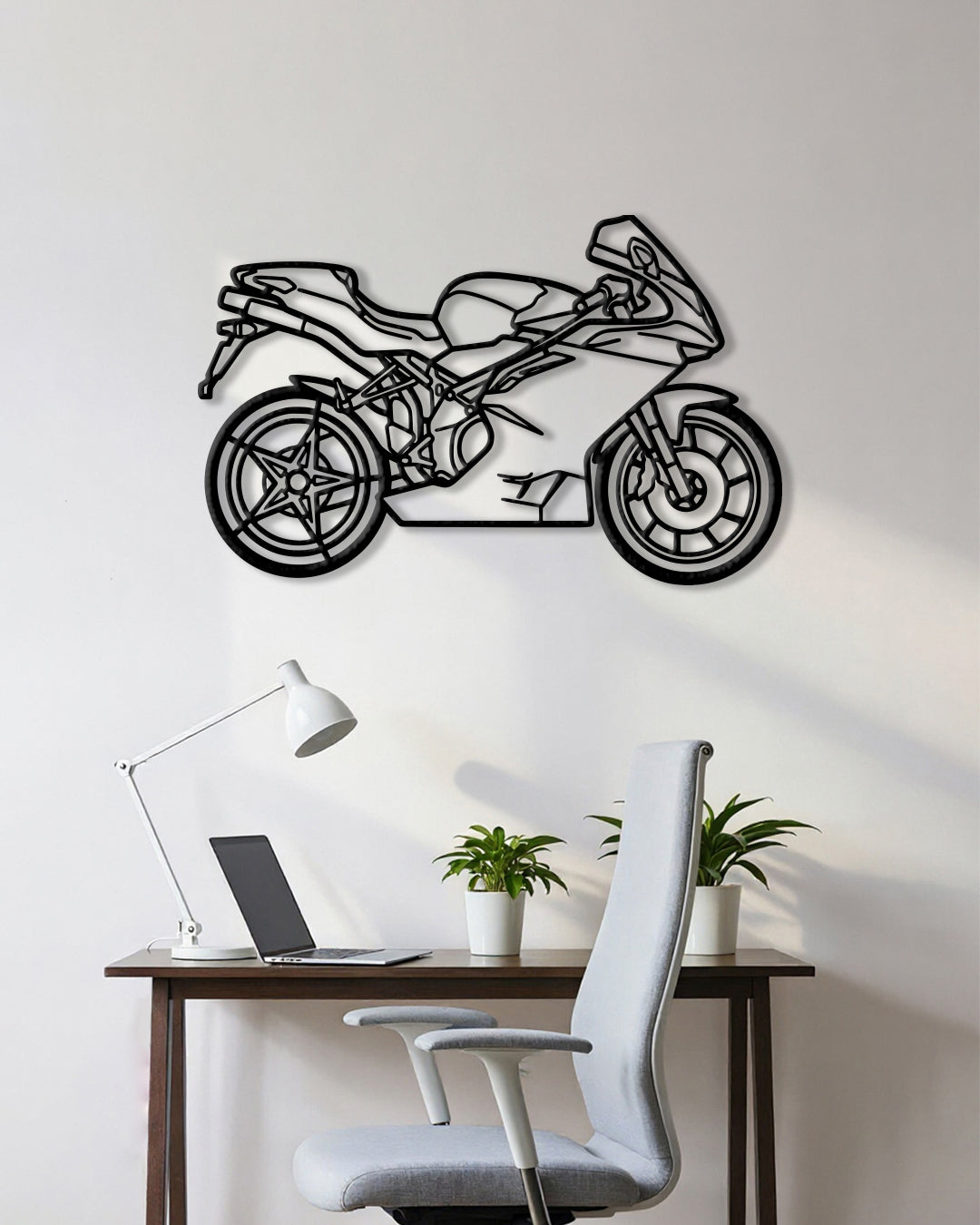 Motorcycle cutout shape made of black metal hanging on the wall