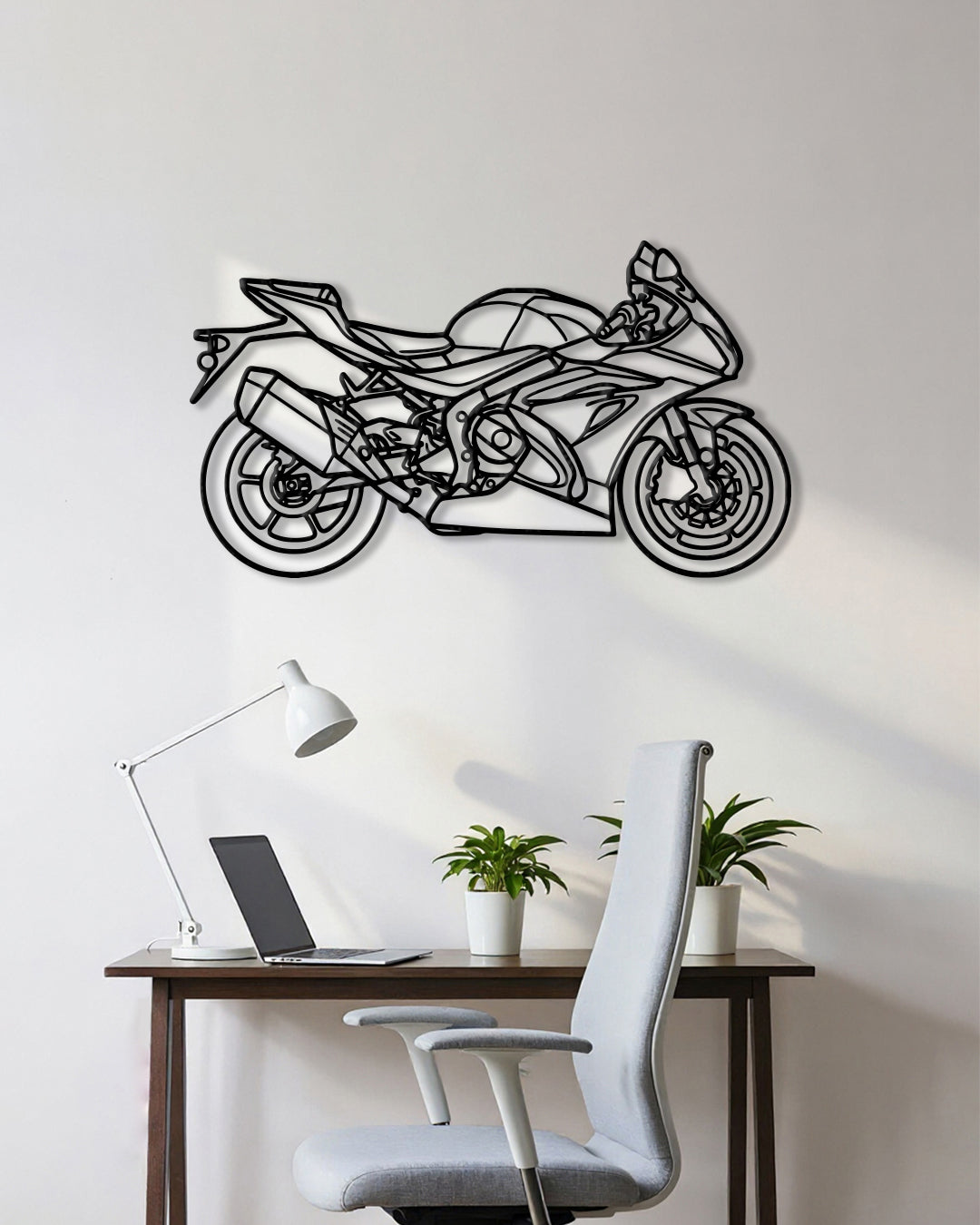 Motorcycle cutout shape made of black metal hanging on the wall