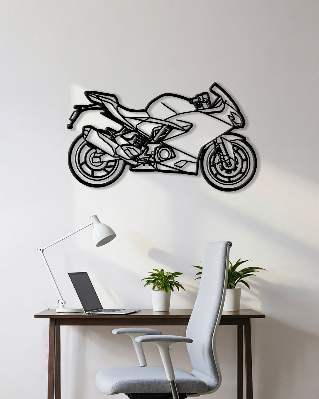 Motorcycle cutout shape made of black metal hanging on the wall