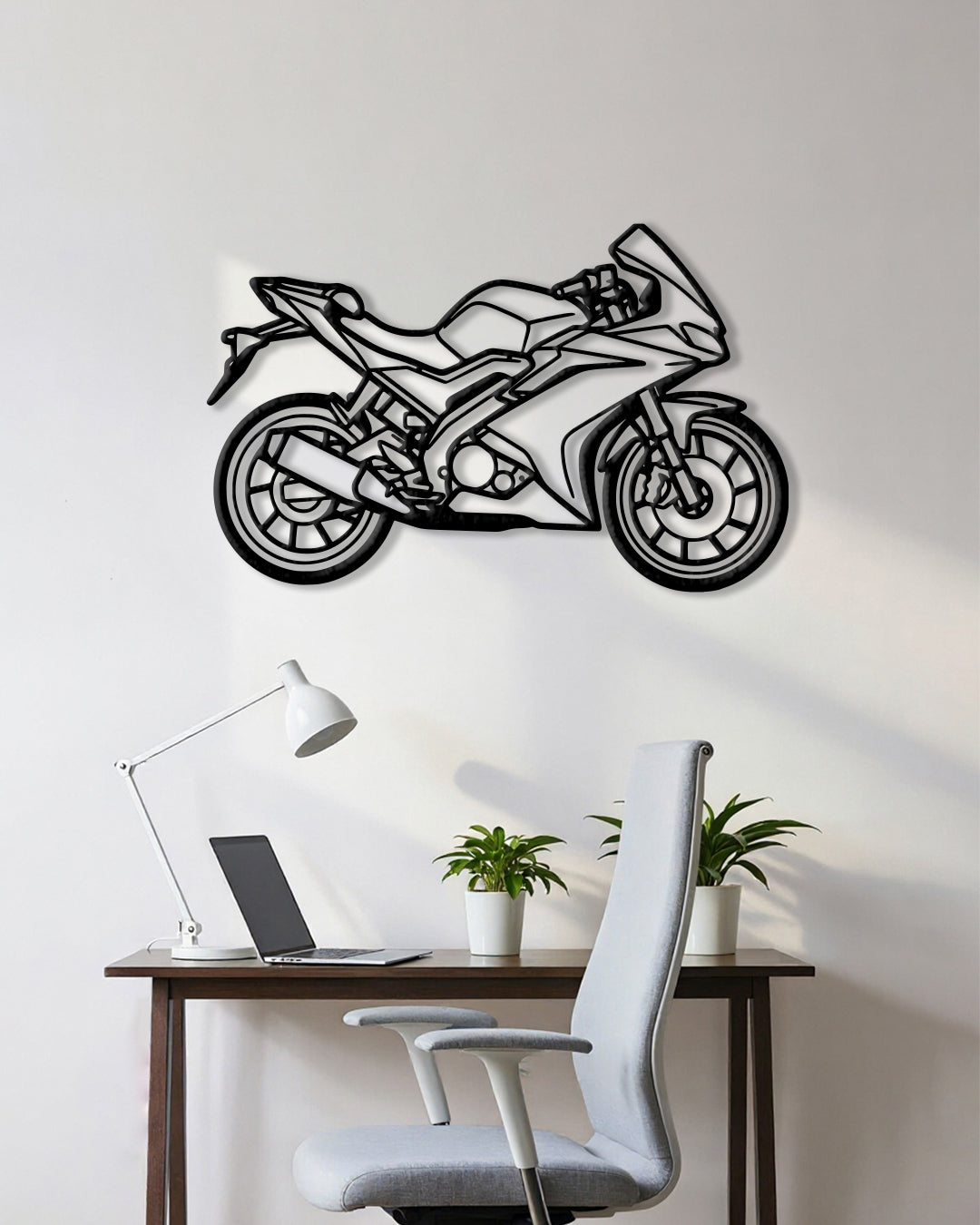 Motorcycle cutout shape made of black metal hanging on the wall