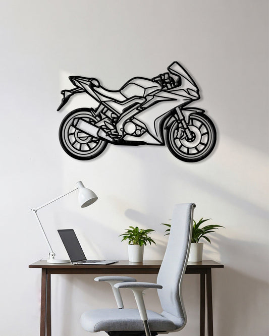 Motorcycle cutout shape made of black metal hanging on the wall