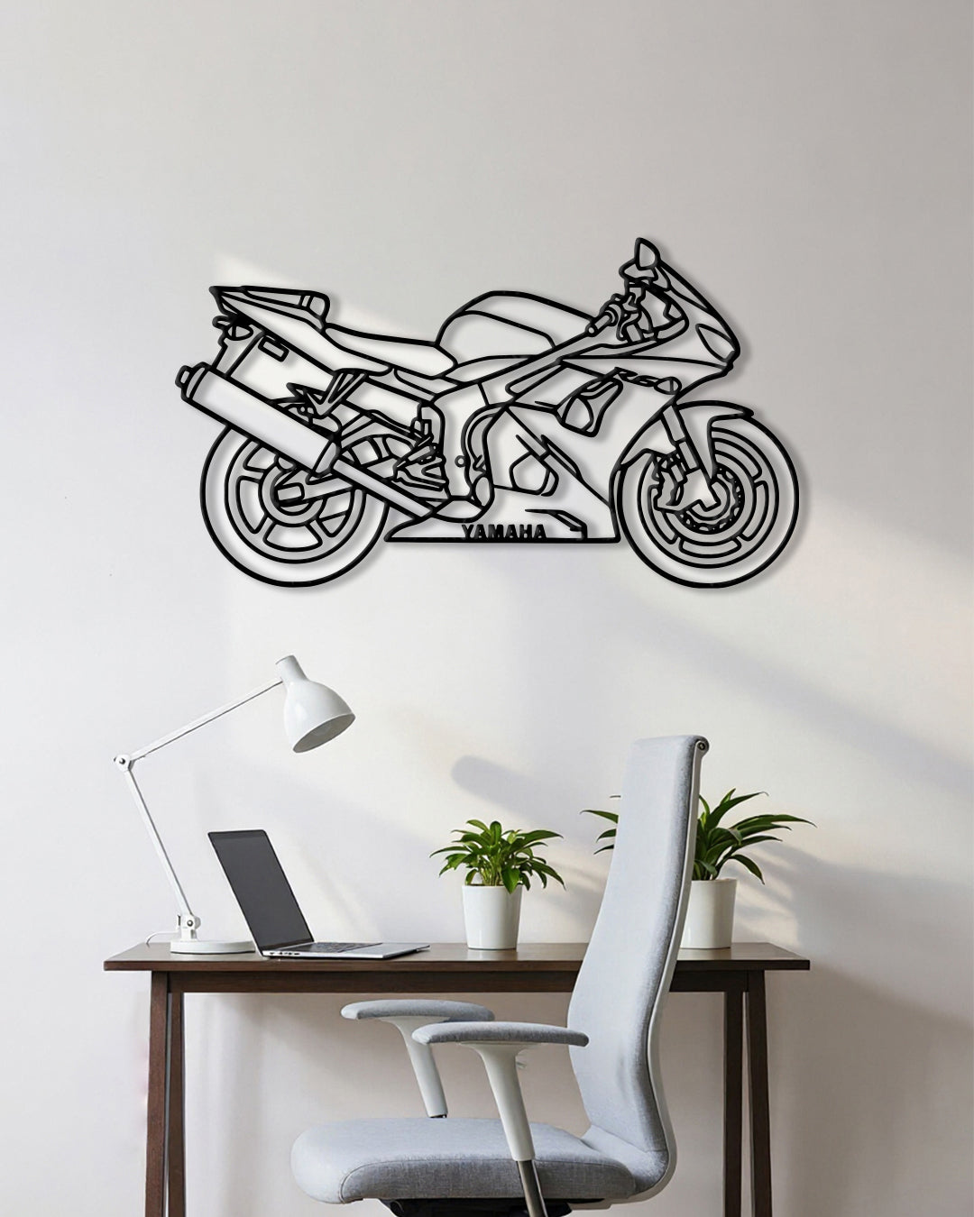 Motorcycle cutout shape made of black metal hanging on the wall